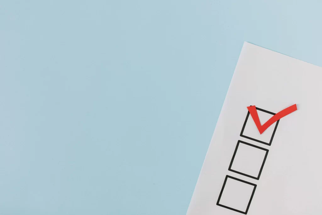 4 Essential HOA Election Rules You Must Follow 3 picture of a white piece of paper with a red tick in one of the three checkboxes against a light blue background to represent HOA election rules