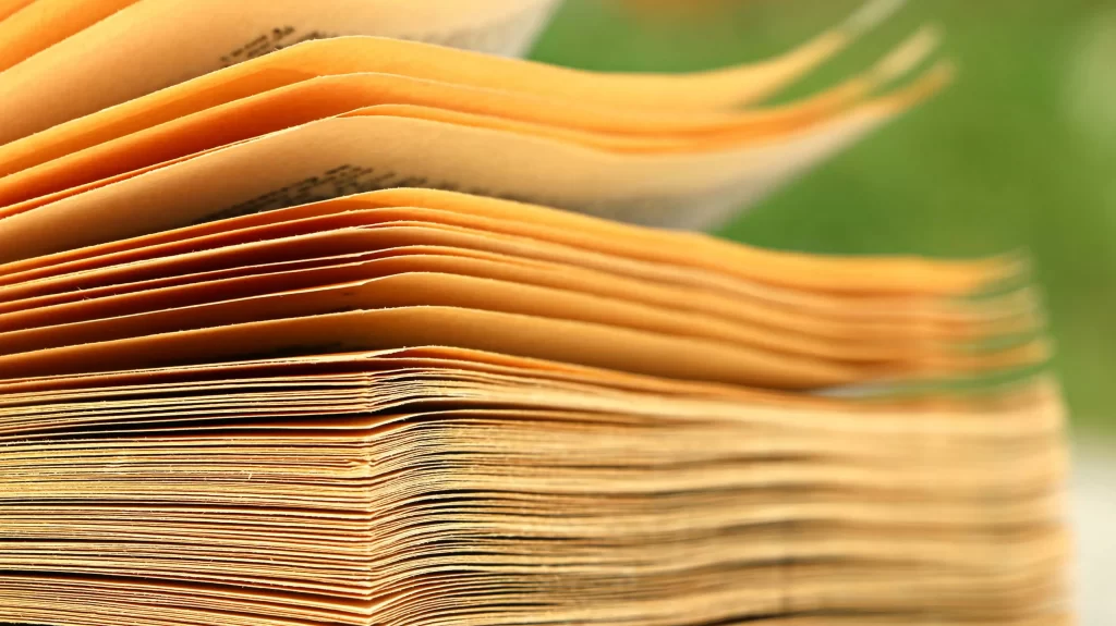 How To Organize Your HOA Document Storage Easily 1 image of yellowing papers stacked up: hoa document storage