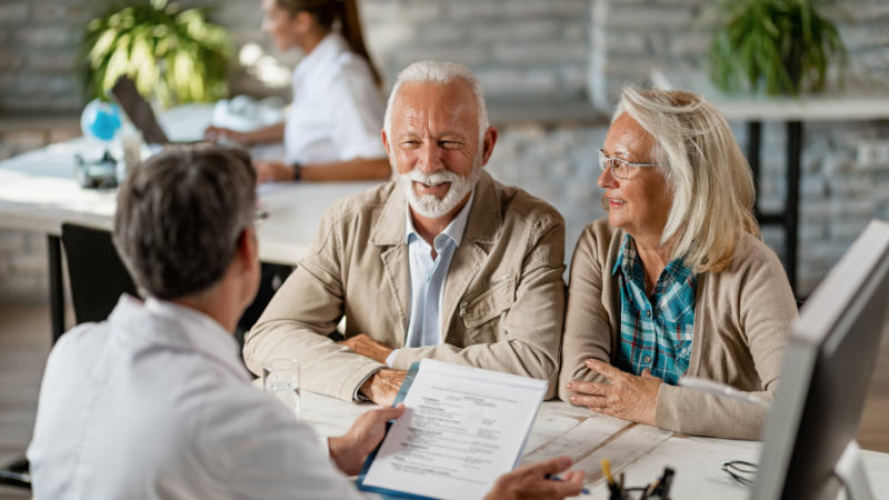 HOA Insurance in Florida: A Helpful Guide With Expert Tips For Board Members 1 An old married couple talking to an expert about HOA Insurance in Florida.